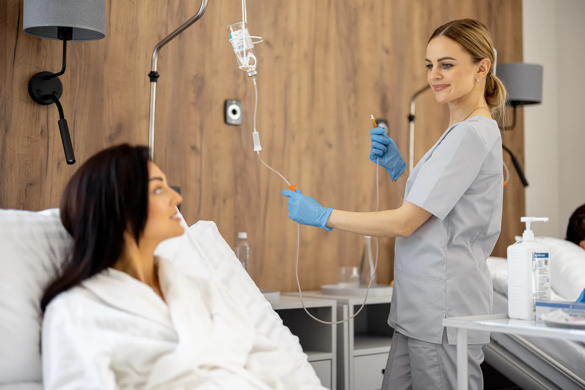 Nurse in medical treatment room with IV equipment