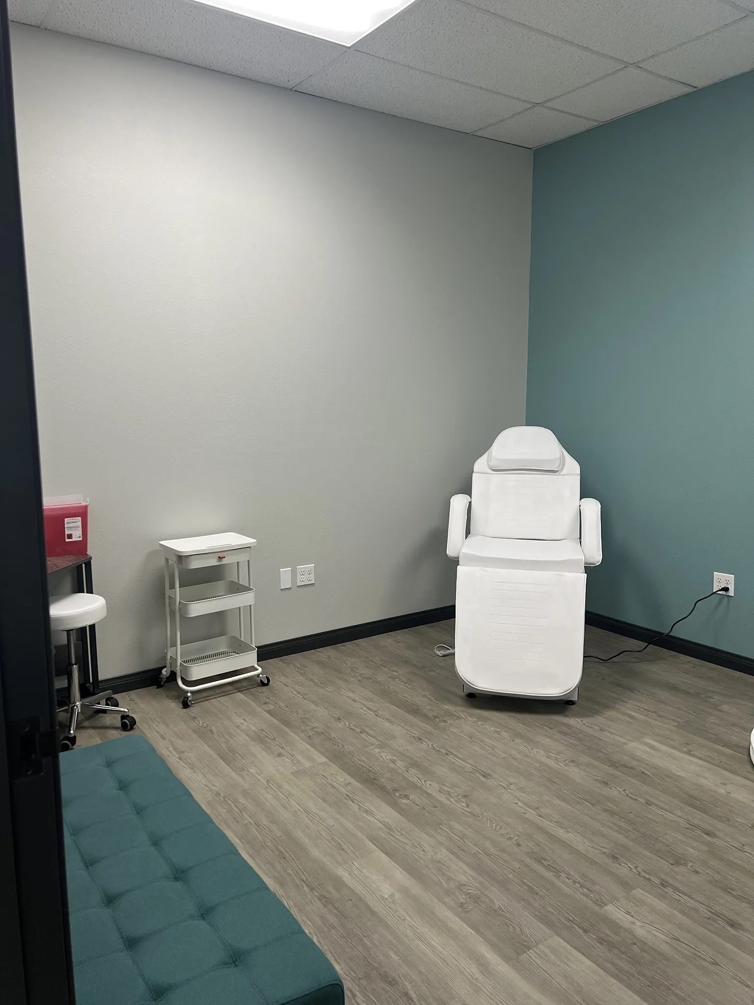 Modern medical treatment room with teal accent wall