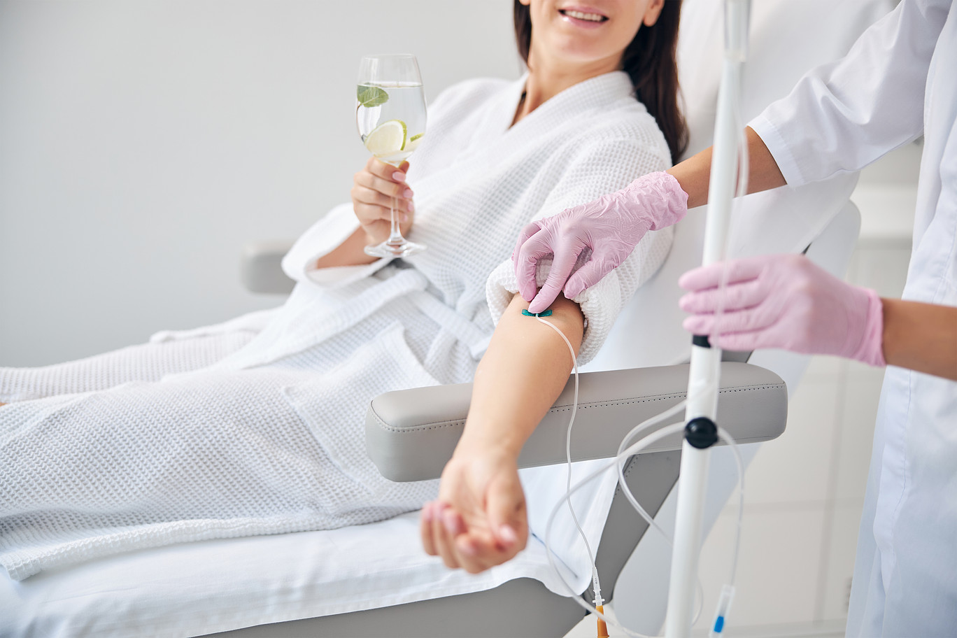 Wellness professional performing IV procedure on patient
